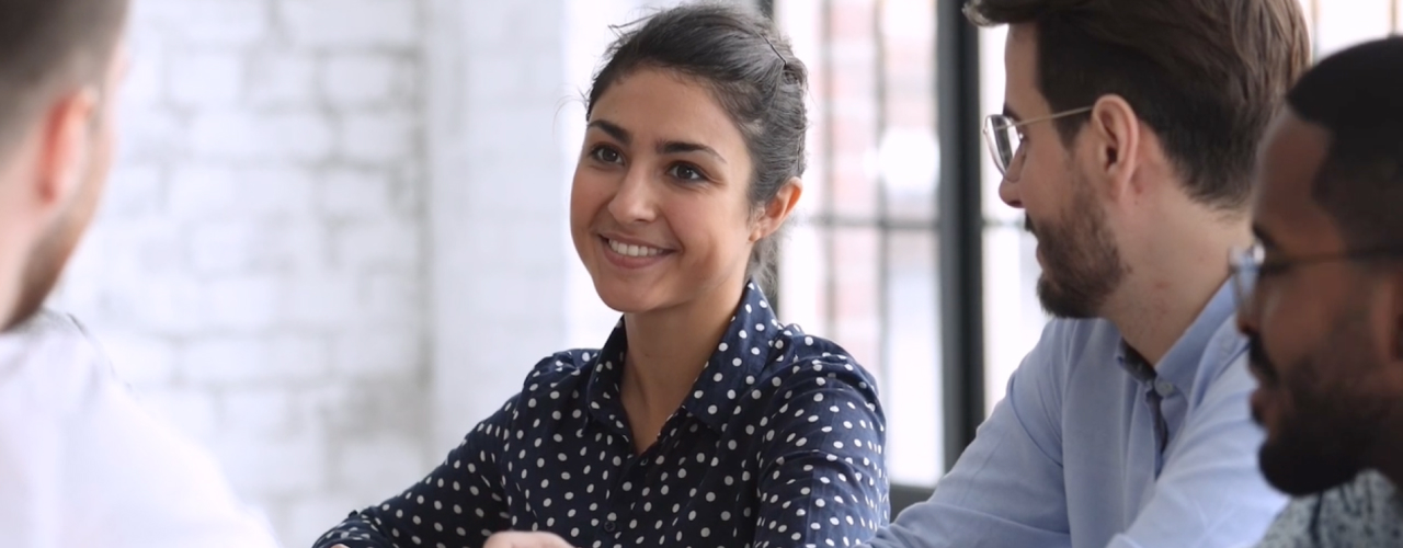 Resourceful. Woman smiling in meeting.